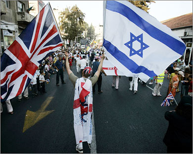 AFP A Christian Evangelical from the United Kingdom waves Israeli and British flags during a parade in celebration of the Jewish holiday of Sukkoth, in downtown