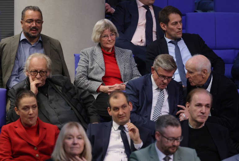 BERLIN, GERMANY - JANUARY 18: Parliamentarians of the far-right Alternative for Germany (AfD), including Gerrit Huy (C, in red sweater), whom Correctiv claims attended the November far-right meeting in Potsdam, attend a debate at the Bundestag over how to defend democracy on January 18, 2024 in Berlin, Germany. The session was called for by the coalition government members in reaction to the revelation of a secret meeting late last year between politicians and far-right extremists. According to Correctiv, the investigative group that has exposed the gathering, politicians from the far right Alternative for Germany (AfD) political party, the German Christian Democrats (CDU)-linked Werteunion, far-right extremists and financial supporters of far-right causes met at a villa in Potsdam last November. Participants at the meeting reportedly discussed how to possibly introduce legislative measures to enable the mass expulsion of immigrants from Germany, as well as German citizens with immigrant roots and German citizens who have helped refugees. News of the meeting has prompted renewed calls for banning the AfD. (Photo by Sean Gallup/Getty Images)