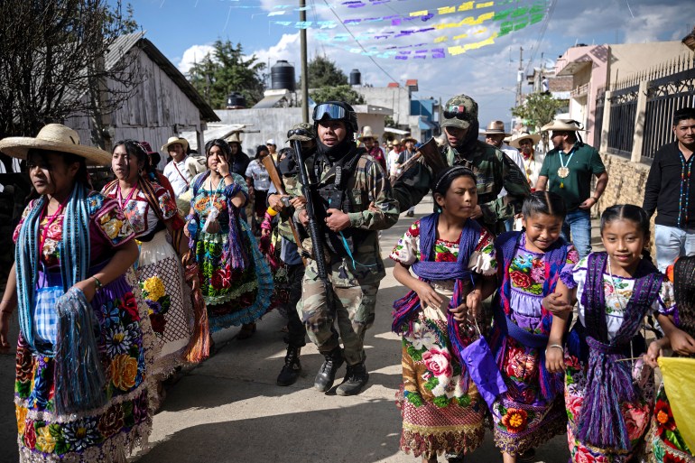 A local self-defense force member attends the Purepecha New Year celebration in Ocumicho, Michoacan State, Mexico, on February 1, 2024. - Every year, Purepecha’s Indigenous people from different regions of Michoacan State celebrate the Fuego Nuevo Purepecha (Purepecha’s New Fire), a fire lighting ceremony to mark the start of the new year. (Photo by CARL DE SOUZA / AFP)