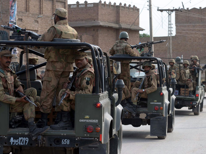 AQ765 - Peshawar, -, PAKISTAN : A Pakistani army convoy patrols the streets on the outskirts of Peshawar on May 10, 2013. Pakistan goes to the polls on May 11 to elect a new government, the first time in the country's turbulent history that one civilian administration has handed power to another through the ballot box. AFP PHOTO/ A. MAJEED