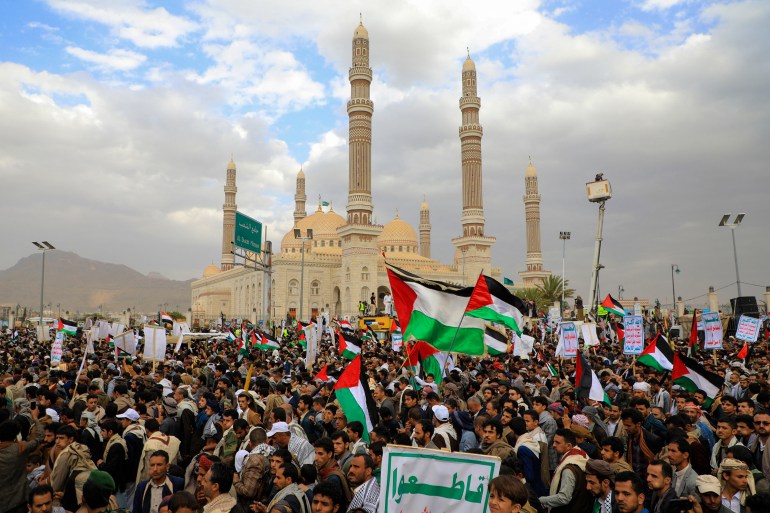 Yemenis lift placards and wave Palestinian flags as they march in the Huthi-run capital Sanaa on February 16, 2024 in support of Palestinians amid ongoing battles between Israel and the militant Hamas group in the Gaza Strip. (Photo by MOHAMMED HUWAIS / AFP)