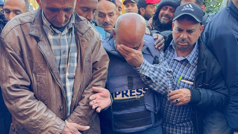 A mourner reacts as Palestinians attend the funeral of Al Jazeera cameraman Samer Abu Daqqa, who according to the Arabic broadcaster was killed by an Israeli drone strike on Friday while reporting on the earlier bombing of a school sheltering displaced people but Israel's military did not respond to a request for comment, in Khan Younis in the southern Gaza Strip December 16, 2023. REUTERS/Bassam Masoud