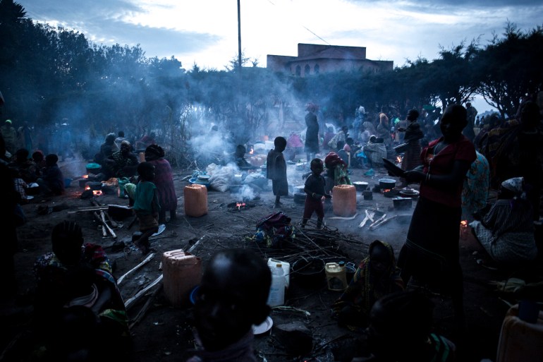 Thousands of displaced Congolese people take refuge in the grounds of a Catholic Church on July 3, 2019 in Drodro, eastern DR Congo. For the last three weeks the FARDC have been fighting in a offensive operation against a militia in the Wago Forest in the Djugu district of Ituria Province. Attacks by this militia and inter-communal fighting between the Lendu and Hema communities have displaced over 300 000 people so far. (Photo by John WESSELS / AFP)