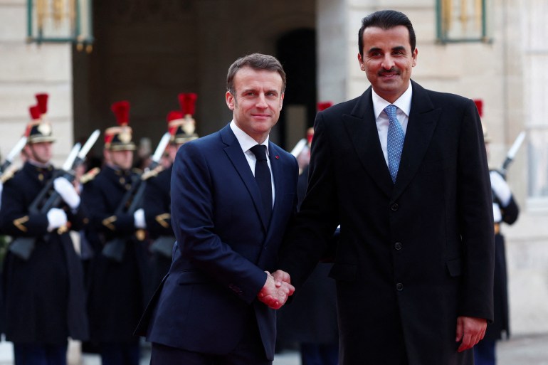 French President Emmanuel Macron shakes hands with Qatar's Emir Sheikh Tamim bin Hamad Al Thani as he arrives for a meeting at the Elysee Palace as part of a two day state visit in Paris, France, February 27, 2024. REUTERS/Gonzalo Fuentes