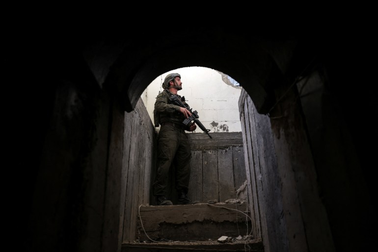 An Israeli soldier stands at the entrance to a tunnel as he operates amid the ongoing conflict between Israel and the Palestinian Islamist group Hamas, in Gaza, January 8, 2024. REUTERS/Ronen Zvulun EDITOR'S NOTE: REUTERS PHOTOGRAPHS WERE REVIEWED BY THE IDF AS PART OF THE CONDITIONS OF THE EMBED. TWO PHOTOS WERE REMOVED BY REUTERS UPON IDF REQUEST, CITING SECURITY CONCERNS. ONE SHOWED A TANK MARKING AND THE OTHER EXPOSED A LOCATION OF TROOPS