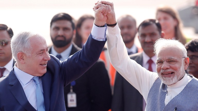 Israeli Prime Minister Benjamin Netanyahu and his Indian counterpart Narendra Modi raise their arms upon Netanyahu’s arrival at Air Force Station Palam in New Delhi, India, January 14, 2018. REUTERS/Adnan Abidi