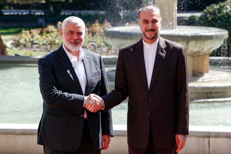 Iran's Foreign Minister Hossein Amir-Abdollahian (R) receives Hamas' Doha-based political bureau chief Ismail Haniyeh at the foreign ministry headquarters in Tehran on March 26, 2024. - Haniyeh's visit to Tehran comes a day after a resolution adopted by the UN Security Council called for an "immediate ceasefire" for the ongoing Muslim holy month of Ramadan, leading to a "lasting" truce. (Photo by AFP)