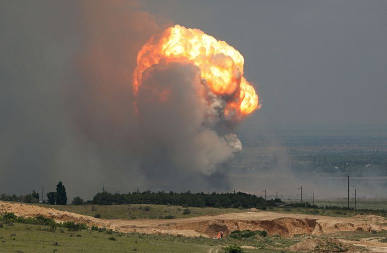 Smoke and flames rise from an explosion during a fire at a military training ground in Crimea