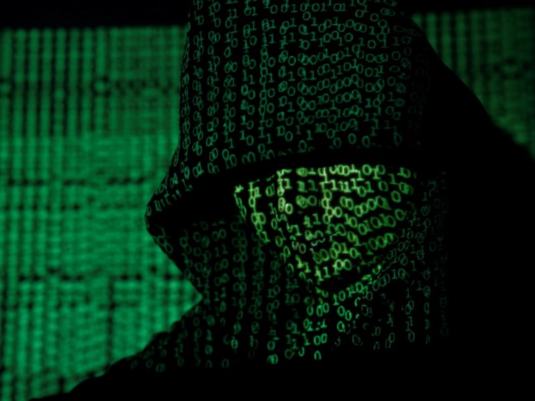 A projection of cyber code on a hooded man is pictured in this illustration picture taken on May 13, 2017. Capitalizing on spying tools believed to have been developed by the U.S. National Security Agency, hackers staged a cyber assault with a self-spreading malware that has infected tens of thousands of computers in nearly 100 countries. REUTERS/Kacper Pempel/Illustration TPX IMAGES OF THE DAY