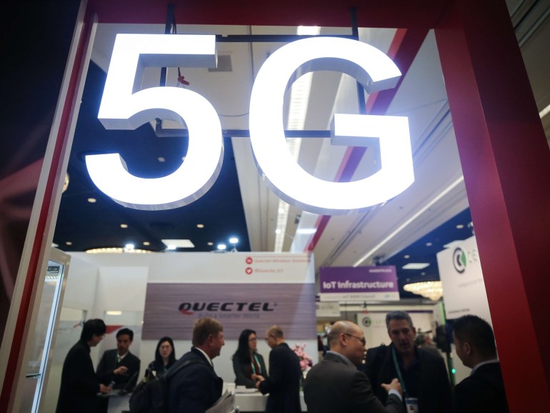 LAS VEGAS, NEVADA - JANUARY 08: Attendees and workers chat beneath a '5G' logo at the Quectel booth at CES 2020 at the Las Vegas Convention Center on January 8, 2020 in Las Vegas, Nevada. CES, the world's largest annual consumer technology trade show, runs through January 10 and features about 4,500 exhibitors showing off their latest products and services to more than 170,000 attendees. Mario Tama/Getty Images/AFP== FOR NEWSPAPERS, INTERNET, TELCOS & TELEVISION USE ONLY ==