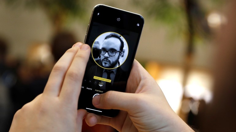 A customer uses the new face-recognition software on the new iPhone X inside the Apple Store in Regents Street in London, Britain, November 3, 2017. REUTERS/Peter Nicholls