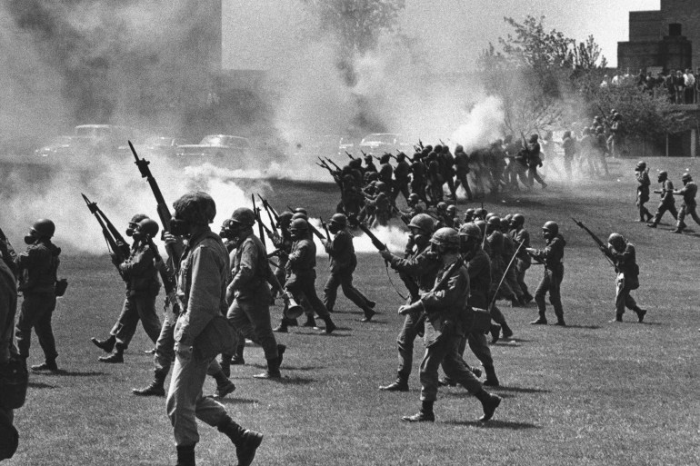 FILE - Ohio National Guard soldiers move in on war protesters at Kent State University in Kent, Ohio, on May 4, 1970. Four people were killed and multiple people were wounded when National Guardsmen opened fire. (AP Photo, File)