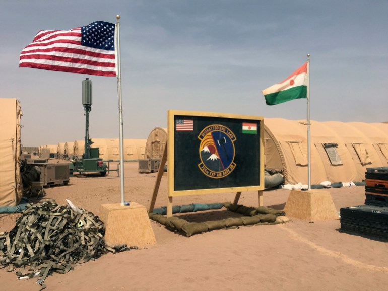 In this photo taken Monday, April 16, 2018, a U.S. and Niger flag are raised side by side at the base camp for air forces and other personnel supporting the construction of Niger Air Base 201 in Agadez, Niger. On the scorching edge of the Sahara Desert, the U.S. Air Force is building a base for armed drones, the newest front in America's battle against the growing extremist threat in Africa's vast Sahel region. Three hangars and the first layers of a runway command a sandy, barren field. Niger Air Base 201 is expected to be functional early next year. (AP Photo/Carley Petesch)