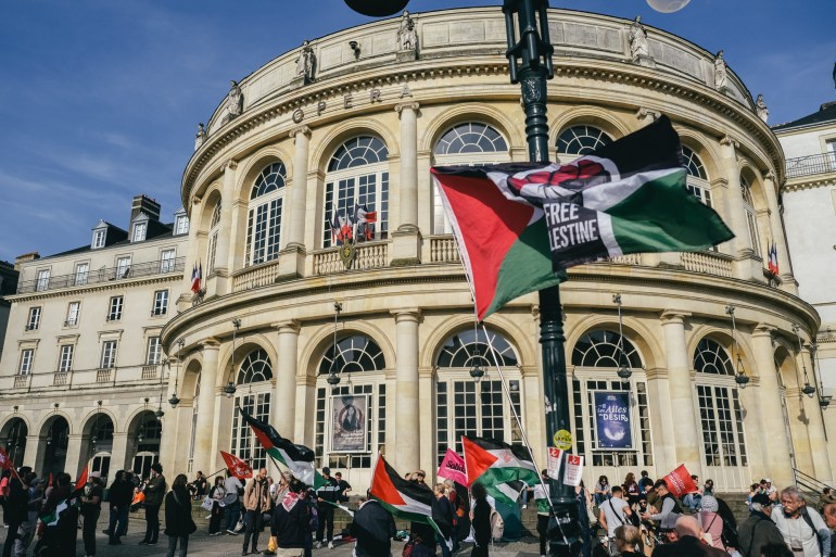 A demonstrator is holding up a Palestinian flag in support of the civilian population during a demonstration in support of Palestine and the civilians of the town of Rafah in Rennes, France, on May 8, 2024. (Photo by Quentin Bonade-Vernault/Nurphoto)