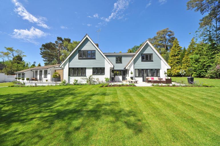 White and Gray Wooden House Near Grass Field