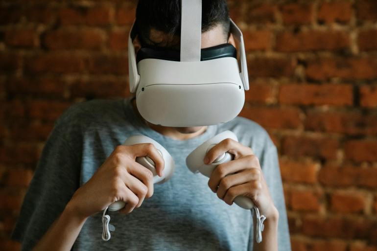 Man in VR headset against brick wall