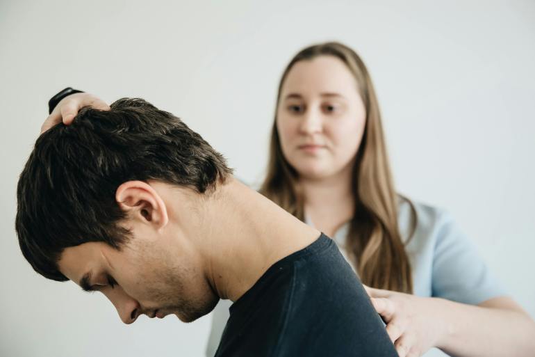 Vilnius, Vilnius County, Lithuania Physiotherapist Helping a Patient Exercise His Neck