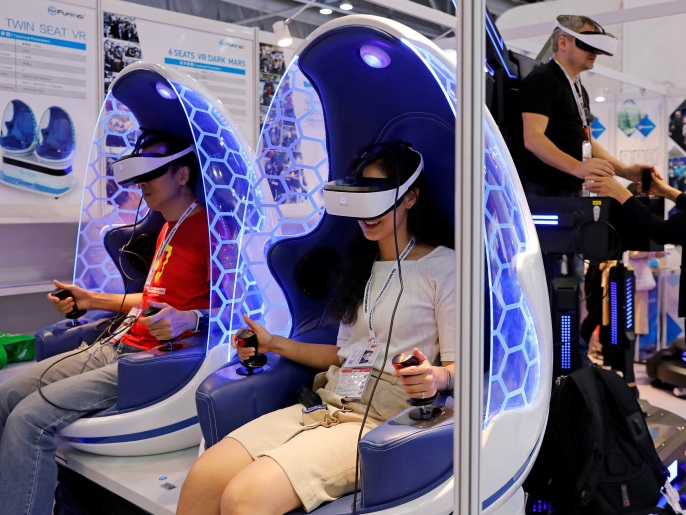 Visitors try Chinese made virtual reality (VR) goggles during Global Sources Mobile Electronics show, in Hong Kong, China April 18, 2018. REUTERS/Tyrone Siu