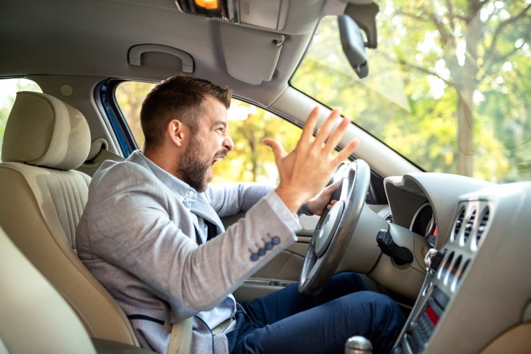 Really angry driver behind the steering wheel cannot keep his calmness