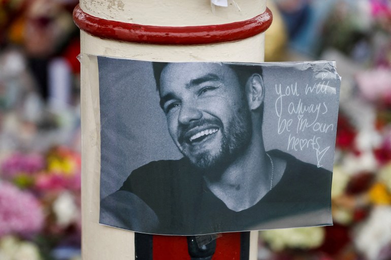 Flowers and tributes are placed at the bandstand in West Park to remember former One Direction singer Liam Payne, in Wolverhampton, Britain November 8, 2024. REUTERS/Temilade Adelaja