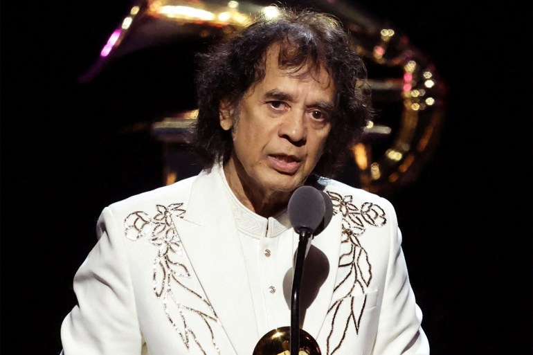 FILE PHOTO: Zakir Hussain accepts the award for Best Global Music Performance for Pashto, by Bela Fleck, Edgar Meyer & Zakir Hussain featuring Rakesh Chaurasia during the Premiere ceremony of the 66th Annual Grammy Awards in Los Angeles, California, U.S., February 4, 2024. REUTERS/Mike Blake/File Photo