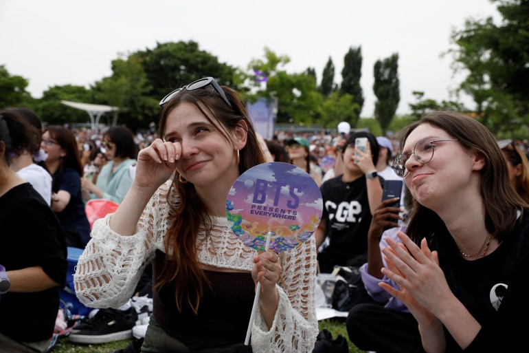 A fan of the K-pop boy band BTS sheds a tear as she listens to the BTS member RM's radio show during BTS 10th Anniversary FESTA in Seoul, South Korea, June 17, 2023. REUTERS/Kim Soo-hyeon