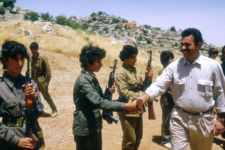 PKK's General Secretary and military leader Abdullah Ocalan greets women soldiers at the Mahsun Korkmaz Academy military training camp. | Location: Lebanon. (Photo by Maher Attar/Sygma via Getty Images)